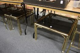 A brass faux bamboo and smoked glass coffee table together with a matching nest of tables.