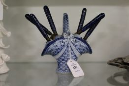 An unusual Dutch Delft basket containing six porcelain handled knives.