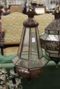 A decorative eastern style patinated metal hanging lantern.