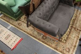 A large Persian style carpet, beige ground with stylized decoration.