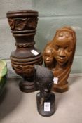 A carved wood bust and a similar vase.