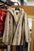 A good ladies' faux fur coat, appears unused.