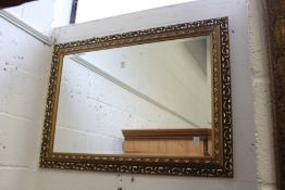 A decorative gilt framed mirror.