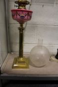 A good brass Corinthian column oil lamp with painted porcelain reservoir.