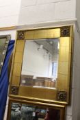A decorative gilt framed mirror.