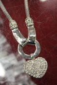 A decorative necklace with heart shaped diamante pendant.