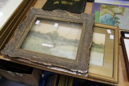 A decorative gilt frame and a pair of prints.