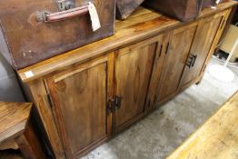 A modern hardwood four door sideboard.