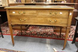 A mahogany side table with two short and one long drawer on tapering square legs.