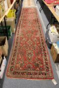 A Persian style red ground runner.