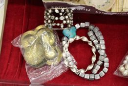 A bag of bijouterie and candle stands.