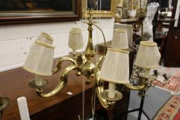 A polished brass six branch chandelier.