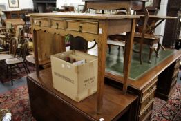 An oak three drawer side table.