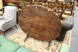 A continental pine oval tilt top dining table.