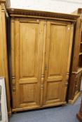 A continental pine two-door armoire.
