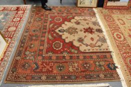 A large Persian style woollen carpet.