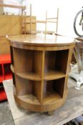 A walnut circular revolving table / bookcase.