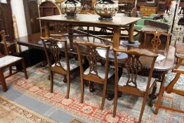 A good George III design mahogany triple pillar extending dining table with two leaves.