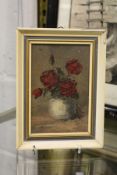 A small oil painting of roses in a vase.