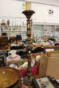 A carved giltwood candle stand.