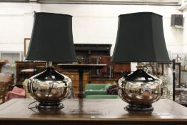 A stylish pair of large chrome plated table lamps with shades.