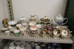 A shelf of decorative tea ware etc.