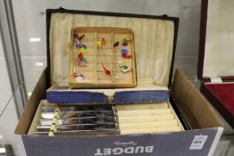 Various cased cutlery and glass cocktail sticks.