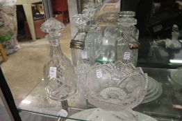 Three decanters and a glass bowl.
