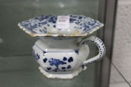 A 19th century blue and white decorated porcelain personal spitoon.