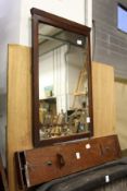 An unusual mahogany storage box and a mirror.