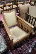 An Arts and Crafts oak reclining armchair.