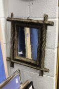An unusual small mirror with carved frame.