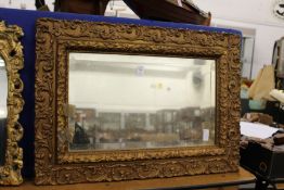 A gilt framed mirror.