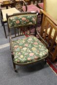 A pretty Victorian low armchair with painted decoration.