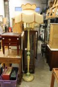 A decoratively painted floor standing lamp with ornate shade and another shade.