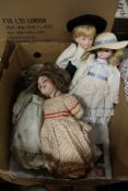 A late Victorian porcelain doll and other modern dolls.