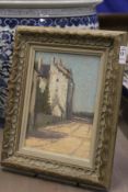 A small street scene with buildings, oil on board.