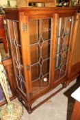 An oak two door display cabinet.