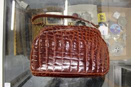 A ladies' crocodile handbag.