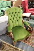 A Victorian walnut framed armchair with button upholstered back.
