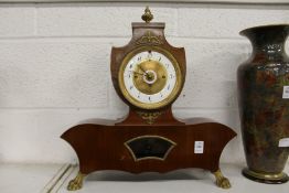 A decorative French mantle clock.