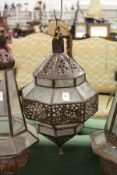 A decorative eastern style patinated metal hanging lantern.
