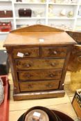 A Victorian walnut miniature chest of drawers.