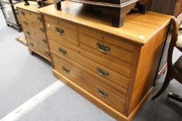 An Edwardian satin and walnut chest of drawers.