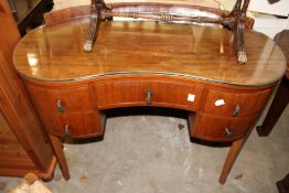 A walnut kidney shaped dressing table.