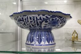 A Chinese blue and white tazza decorated with flowers and bamboo, with a shaped rim.