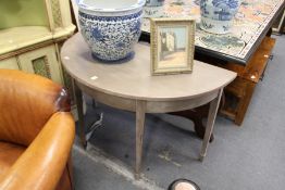 A painted demi-lune side table.