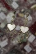A pair of heart shaped earrings.