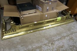 An ornate brass fender.