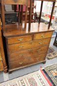 A George III oak chest of two short and three graduated long drawers on bracket feet.